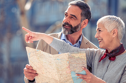 Eine Frau erklärt einem Mann den Weg anhand eines Stadtplans.
